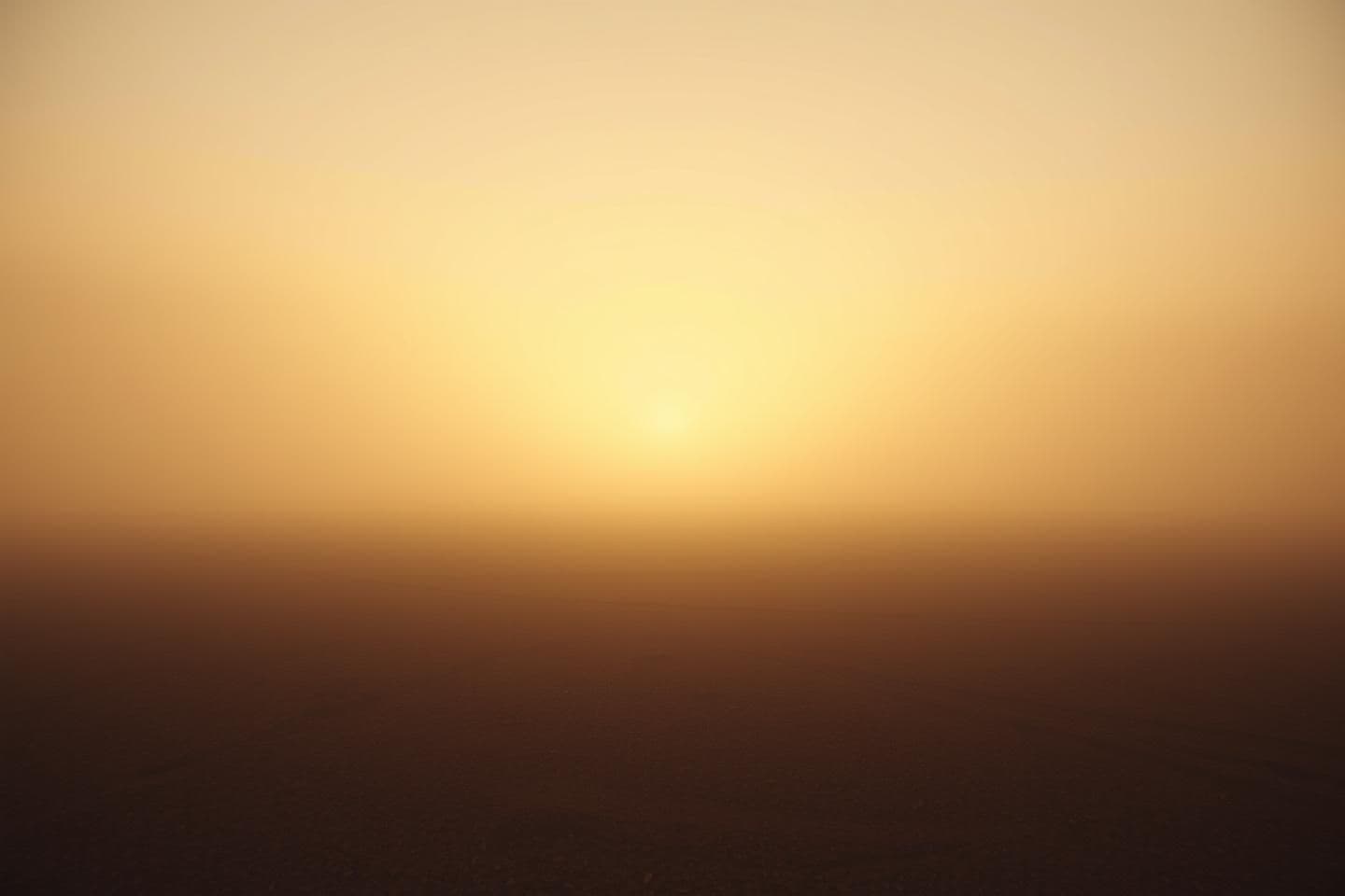 AI generated: A highly stylized 3D render of a vast, empty, fog-soaked landscape where the air seems to vibrate with unseen presence, with no characters present. The lighting matches a dim, mute