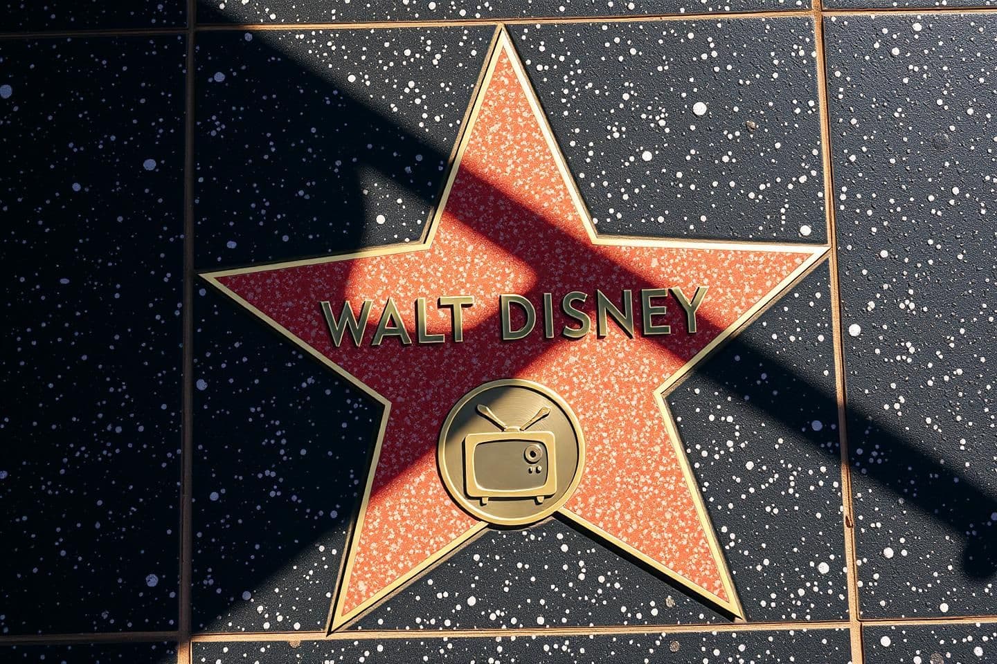 AI generated: A photorealistic, top-down street photography shot of the Walt Disney star on the Hollywood Walk of Fame. The star is five-pointed, made of coral-pink terrazzo with a brass border,